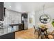 Modern kitchen and dining area with stainless steel appliances, dark cabinets, and hardwood floors at 3321 W 29Th Ave, Denver, CO 80211