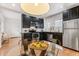 Well-lit kitchen with stainless steel appliances, dark cabinetry, subway tile backsplash, and hardwood floors at 3321 W 29Th Ave, Denver, CO 80211