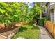 Well-maintained yard with lush grass and a charming stone walkway at 3321 W 29Th Ave, Denver, CO 80211