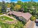 Aerial perspective of a home with mature landscaping, a brick facade, and a well-manicured lawn at 4000 S Dahlia St, Cherry Hills Village, CO 80113
