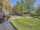 Lush backyard featuring a stone retaining wall and well-maintained landscaping at 4000 S Dahlia St, Cherry Hills Village, CO 80113