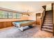 Finished basement area featuring a pool table, wood-paneled walls, and staircase at 4000 S Dahlia St, Cherry Hills Village, CO 80113
