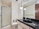 Cozy bathroom featuring a shower, toilet, and sink with dark, marble countertop at 4000 S Dahlia St, Cherry Hills Village, CO 80113