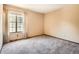 A sunlit bedroom featuring a large window with neutral walls and carpeting at 4000 S Dahlia St, Cherry Hills Village, CO 80113