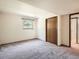 Bedroom with neutral walls, carpeting, window, and a closet with wooden doors at 4000 S Dahlia St, Cherry Hills Village, CO 80113
