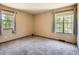 Bedroom featuring dual windows with modern curtains, neutral walls, and carpeting at 4000 S Dahlia St, Cherry Hills Village, CO 80113