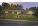 Charming front yard with manicured lawn and tasteful landscaping that enhances the home's curb appeal at 4000 S Dahlia St, Cherry Hills Village, CO 80113