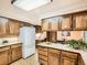 Open kitchen featuring wooden cabinets, white appliances, and bright natural light at 4000 S Dahlia St, Cherry Hills Village, CO 80113