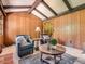 Warm living room featuring beamed ceilings, wood paneled walls, and neutral accents at 4000 S Dahlia St, Cherry Hills Village, CO 80113