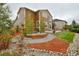 Expansive backyard featuring a patio, a fire pit, and artful landscaping with rocks, mulch, and greenery at 353 Zuniga St, Brighton, CO 80601