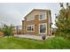 A view of the home's backyard showcasing a patio area, lush green lawn, and well-maintained landscaping at 353 Zuniga St, Brighton, CO 80601
