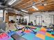 Finished basement with a workout area, including weightlifting equipment and a bench, providing fitness options at home at 353 Zuniga St, Brighton, CO 80601