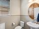 Half bathroom featuring pedestal sink, decorative mirror, and neutral wall colors at 353 Zuniga St, Brighton, CO 80601
