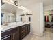 Spacious bathroom features a double-sink vanity with modern fixtures and an adjacent walk-in closet at 353 Zuniga St, Brighton, CO 80601