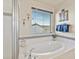 Bright bathroom features a soaking tub, a shower with glass enclosure, and decorative wall art at 353 Zuniga St, Brighton, CO 80601