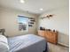 Neutral bedroom has a window with neighborhood views and a dresser with decor at 353 Zuniga St, Brighton, CO 80601