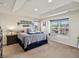 Comfortable bedroom features a tray ceiling and a large window with neighborhood views at 353 Zuniga St, Brighton, CO 80601