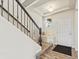 Inviting entryway with stairs, a neutral color palette, and natural wood flooring at 353 Zuniga St, Brighton, CO 80601
