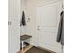 Entryway features white door, coat rack, and bench with storage, creating a welcoming and organized space at 353 Zuniga St, Brighton, CO 80601