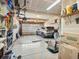 Spacious garage with an open door and a car parked inside, offering ample storage and parking space at 353 Zuniga St, Brighton, CO 80601