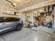 Well-organized garage featuring storage shelves, tools, and a vehicle, providing convenience and functionality at 353 Zuniga St, Brighton, CO 80601