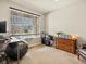 Bright office space with a large window, desk, and comfortable seating at 353 Zuniga St, Brighton, CO 80601