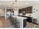 Modern kitchen featuring dark cabinets, stainless steel appliances, and a large center island at 353 Zuniga St, Brighton, CO 80601