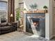Living room showcasing a cozy fireplace with stone surround and wooden mantle at 353 Zuniga St, Brighton, CO 80601