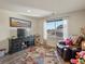 Cozy living room with a TV, a comfortable armchair, and a window with blinds at 353 Zuniga St, Brighton, CO 80601