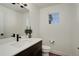 Contemporary powder room with a modern vanity, sleek fixtures, and a decorative mirror at 10334 Milwaukee Cir, Thornton, CO 80229