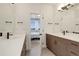 Bathroom featuring double sinks, modern hardware, and connecting door to the main bedroom at 10334 Milwaukee Cir, Thornton, CO 80229