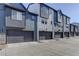 Exterior view of modern townhomes featuring attached garages and contemporary design at 10334 Milwaukee Cir, Thornton, CO 80229