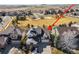 Aerial view of a light gray house with a playground nearby and an arrow pointing to the house at 16650 E Timberwolf Ln, Parker, CO 80134