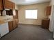 Efficient kitchen layout with wood cabinets, laminate countertops and carpet flooring at 16685 W 11Th Ave, Golden, CO 80403