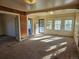 Spacious living room with carpet, wood paneling, and lots of natural light from multiple windows at 16685 W 11Th Ave, Golden, CO 80403