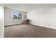 Bright bedroom filled with natural light and neutral colored carpet flooring at 7395 E Quincy Ave # 305, Denver, CO 80237