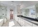 Modern bathroom with marble floors, double vanity, and walk-in shower at 39555 Gwinett Cir, Elizabeth, CO 80107