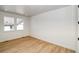 Well-lit bedroom featuring hardwood floors, two windows, and white walls for a bright, welcoming feel at 39555 Gwinett Cir, Elizabeth, CO 80107