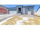 Charming exterior showing stone accents, a concrete driveway, and a two-car garage at 39555 Gwinett Cir, Elizabeth, CO 80107