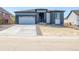 Beautiful single Gathering home with a grey exterior, two car garage, and manicured lawn at 39555 Gwinett Cir, Elizabeth, CO 80107