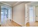 Bright hallway featuring wood floors, leading to various rooms and showcasing the home's open layout at 39555 Gwinett Cir, Elizabeth, CO 80107