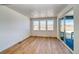Bright and airy living room with wood floors and a sliding glass door to an outdoor balcony at 39555 Gwinett Cir, Elizabeth, CO 80107