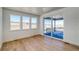 Bright living area with wood floors, large windows, and sliding door to outdoor space with distant views at 39555 Gwinett Cir, Elizabeth, CO 80107