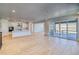 An open floor plan showing a kitchen with an island, a living room, and large sliding glass doors to the patio at 39555 Gwinett Cir, Elizabeth, CO 80107