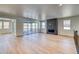 Spacious living room with hardwood floors, a modern fireplace, and plenty of natural light at 39555 Gwinett Cir, Elizabeth, CO 80107