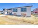 A home's rear elevation featuring large windows and a covered porch for outdoor relaxation at 39555 Gwinett Cir, Elizabeth, CO 80107