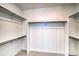 Organized walk-in closet featuring built-in shelving and ample storage space for clothes and accessories at 39555 Gwinett Cir, Elizabeth, CO 80107