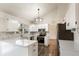 Bright kitchen featuring white cabinets, stone backsplash, stainless steel appliances, quartz countertops and hardwood floors at 3915 E Jamison Pl, Centennial, CO 80122