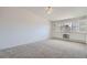 Bright bedroom with large windows, carpet floors, and ceiling fan at 650 S Clinton St # 4D, Denver, CO 80247