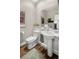 Charming half-bath with pedestal sink and decorative mirror at 216 N Monroe St, Denver, CO 80206